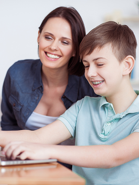 Happy,Mother,Helping,His,Son,To,Do,Homework